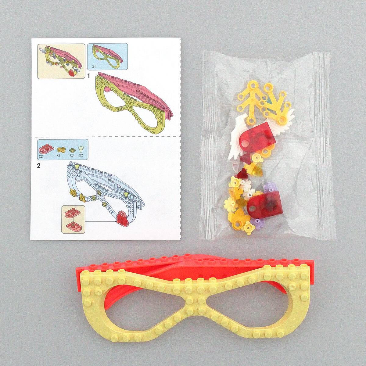 Instruction manual and building pieces for the pink and yellow Kids DIY Glasses Building Block Set. Easy-to-follow guide for creative assembly.
