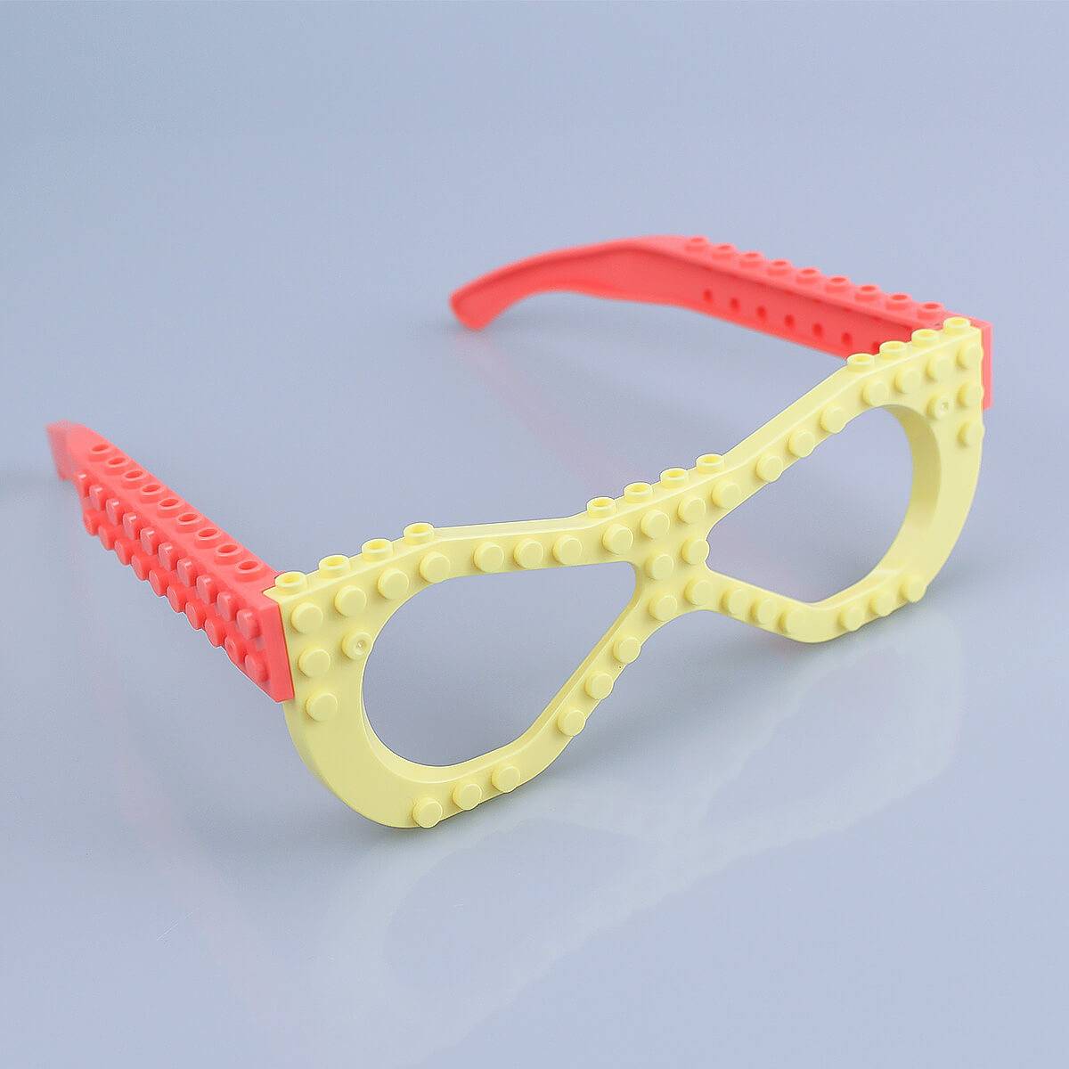 Unassembled yellow Kids DIY Glasses Building Block Set with decorative pieces including flowers and wings. Fun and creative toy for kids.