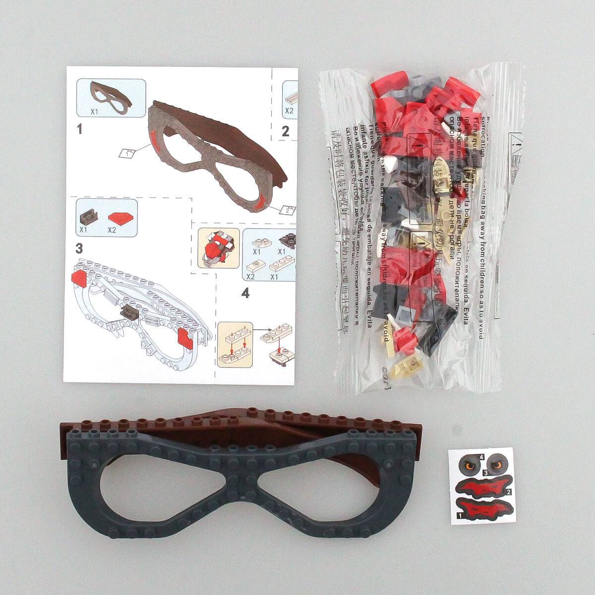 Instruction manual and building pieces for the dinosaur-themed Kids DIY Glasses Building Block Set. Easy-to-follow guide for creative assembly.