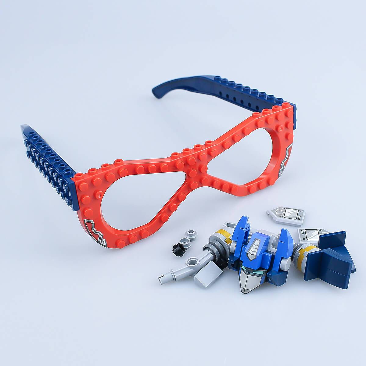 Unassembled mechanical-themed Kids DIY Glasses Building Block Set with red and blue frames and various building pieces. Encourages hands-on creativity.