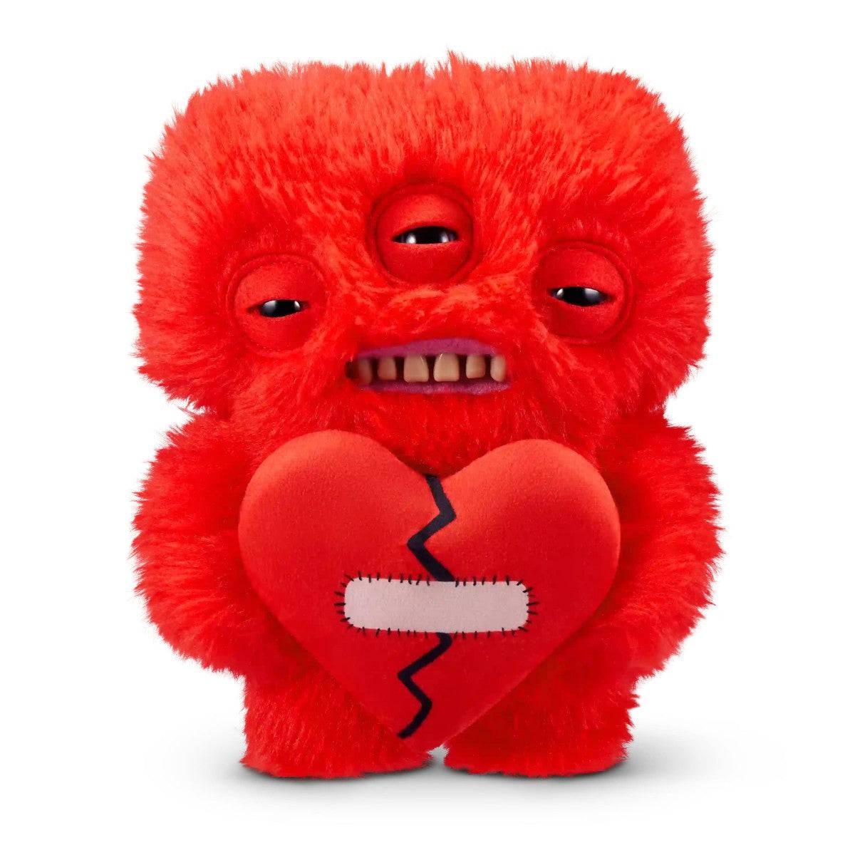 FUGGLER Soft Plush Toy in red fur holding a broken heart. A quirky Valentine's plush for collectors and gift-givers.
