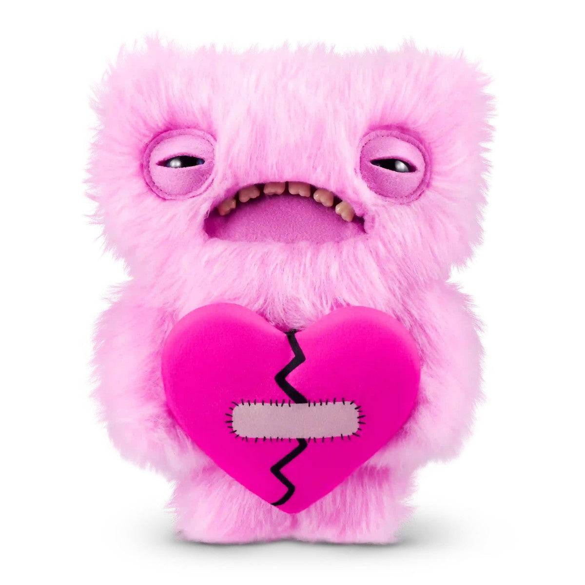 FUGGLER Soft Plush Toy in pink fur with sleepy eyes and stitched heart. A soft and strange plush for themed toy collections.