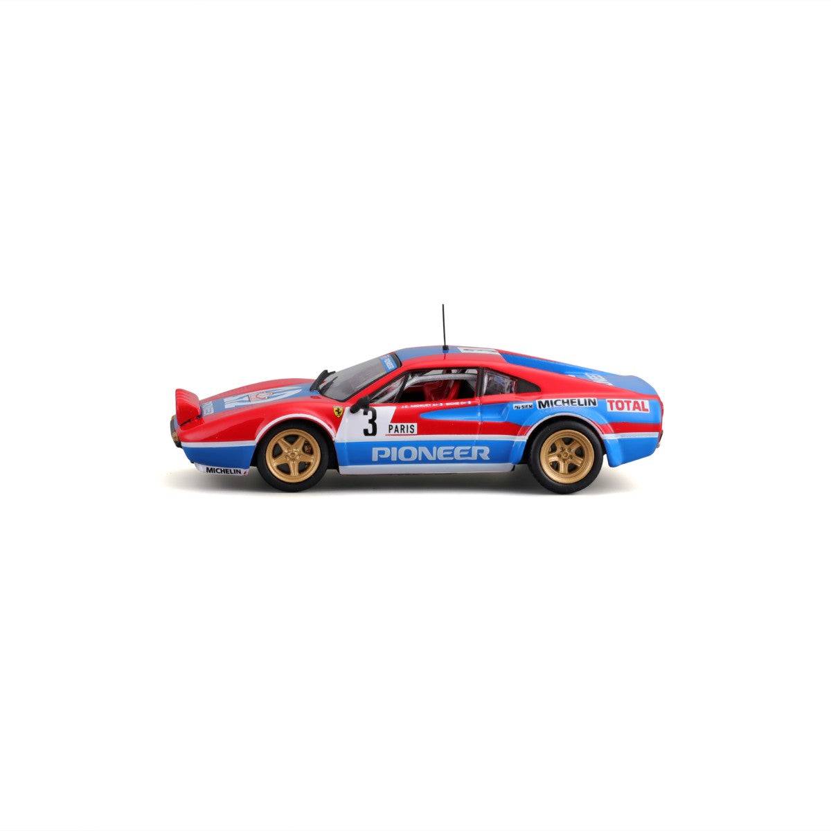 Side profile of Bburago 1:43 Ferrari 308 GTB 1982 model car with racing decals, gold wheels, and aerodynamic bodywork.