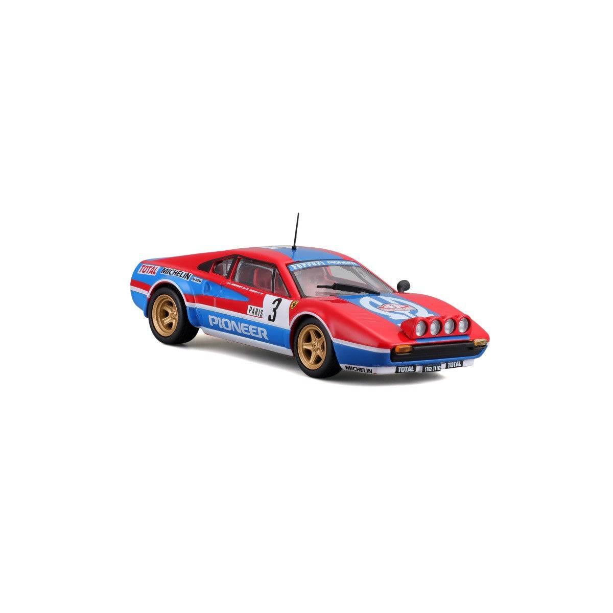 Angled front view of Bburago 1:43 Ferrari 308 GTB 1982 model car highlighting rally headlights, racing livery, and gold wheels.