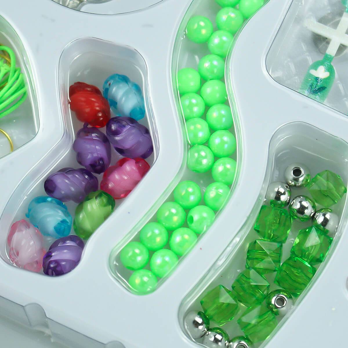 Colorful kids' DIY jewelry-making kit with assorted beads in green, silver, and multicolor swirls. Perfect for creative crafting fun.