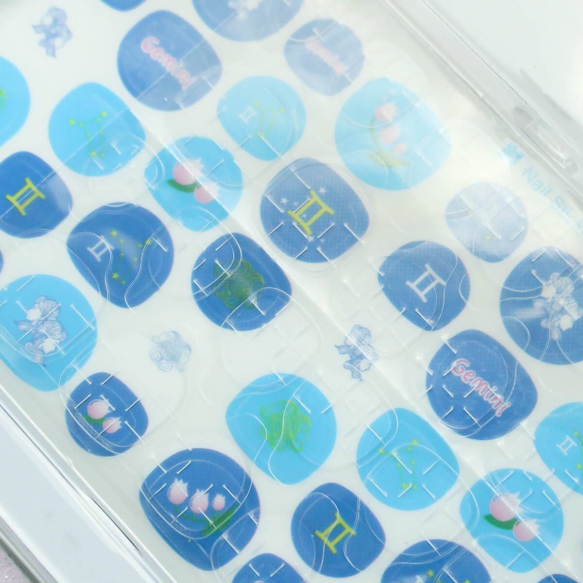 Zodiac-themed nail stickers from the 12 Zodiac Signs Kids Nail Art Set HW23158395, featuring Gemini-inspired blue designs.