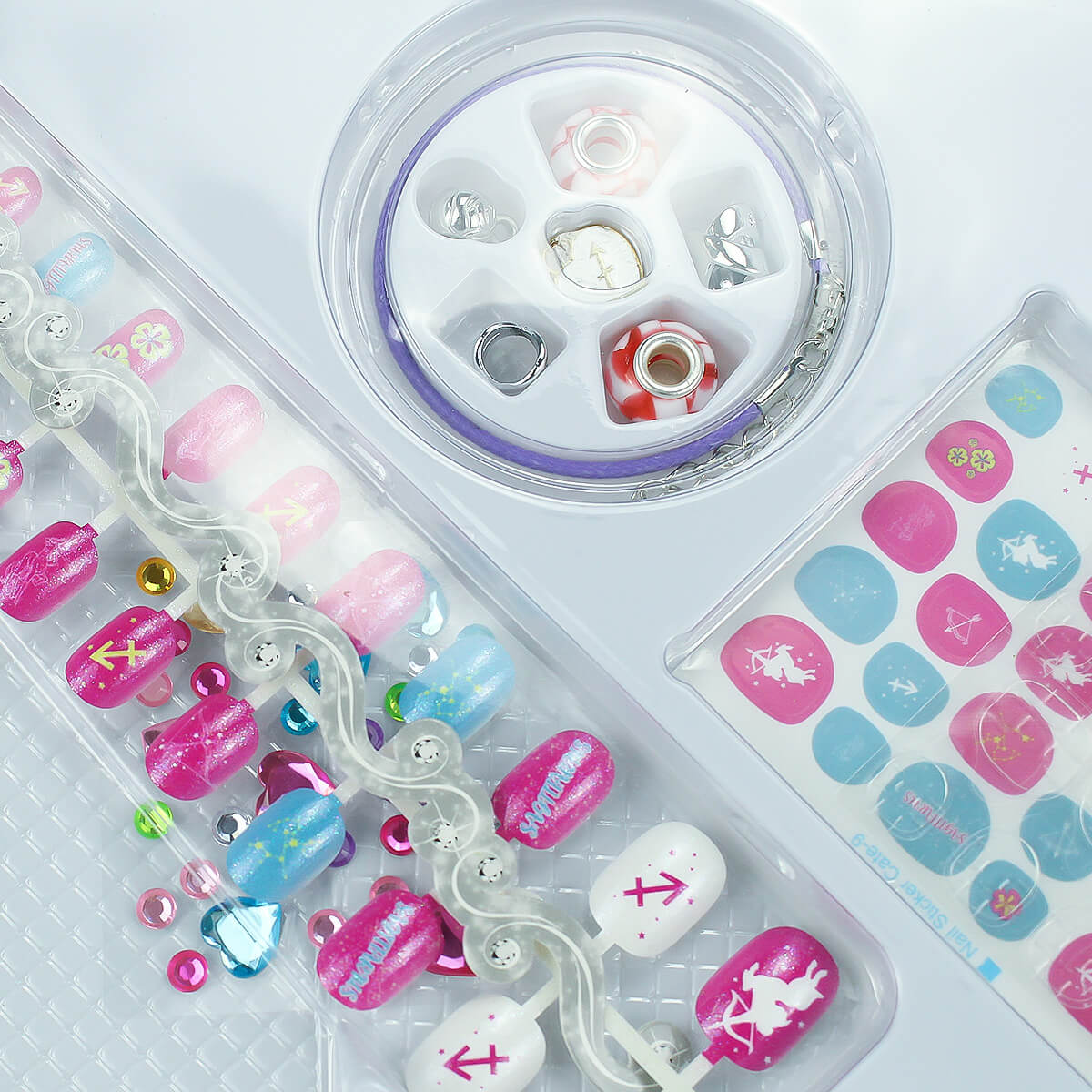 12 Zodiac Signs Kids Nail Art Set HW23158395 by HugmieToys, featuring pink and blue nail designs, zodiac-themed stickers, and decorative gems for creative fun.