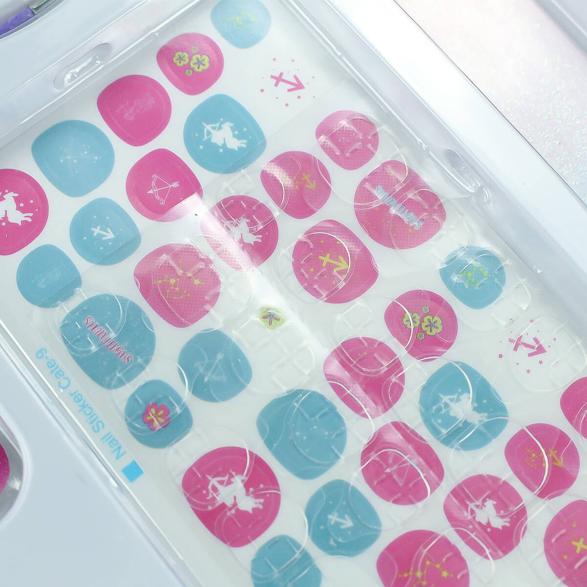 12 Zodiac Signs Kids Nail Art Set HW23158395 by HugmieToys, featuring pink and blue nail stickers with zodiac-themed designs. A fun, non-toxic DIY nail art kit for kids.