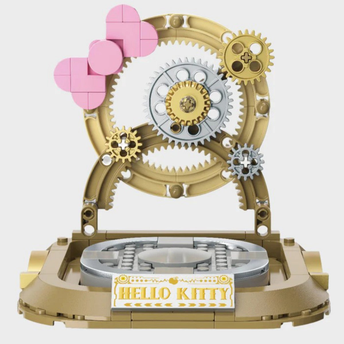 Display base of the TOPTOY Hello Kitty White Golden Big Figure Building Blocks featuring pink bow elements and gold gear decorations.