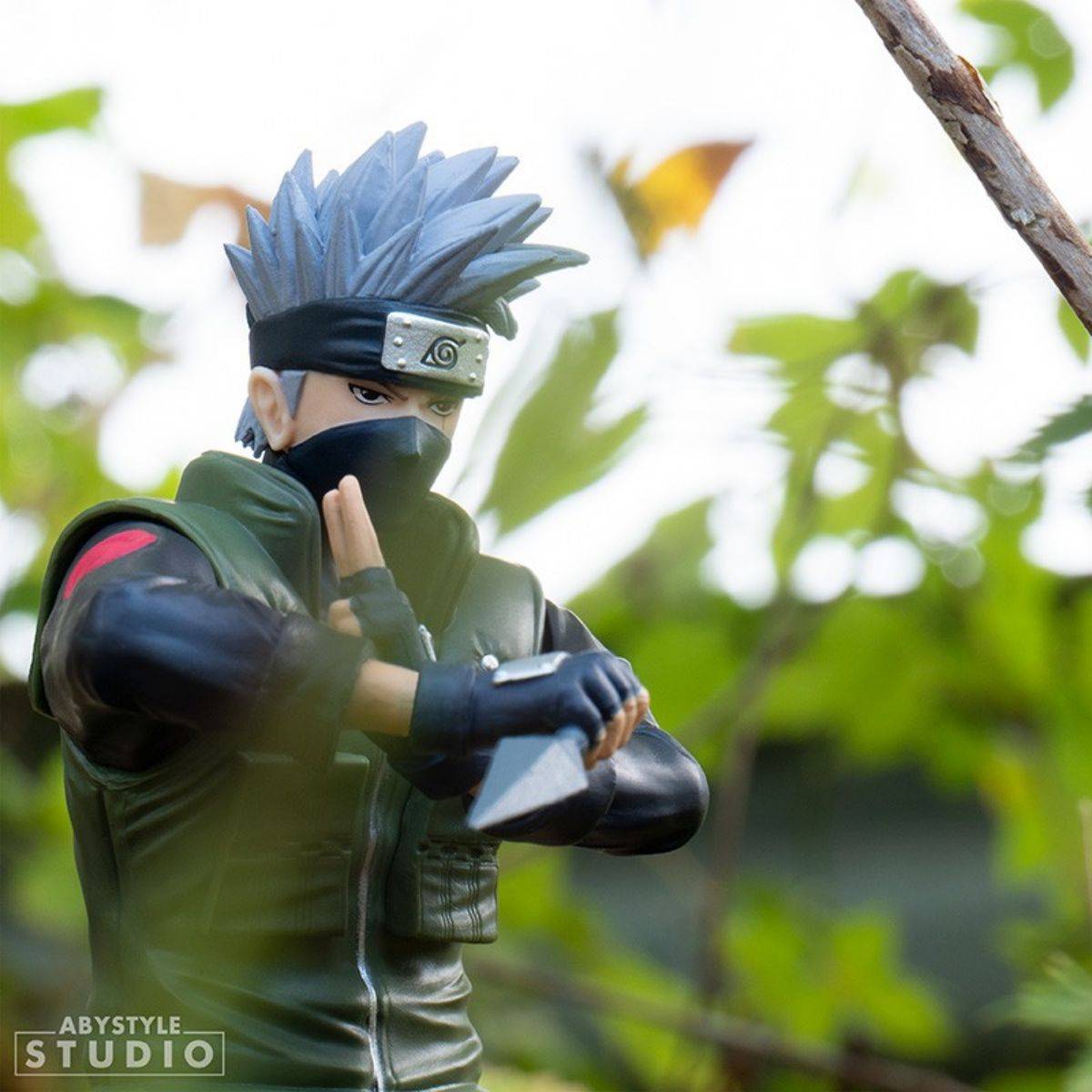 ABYstyle Studio Naruto Shippuden Kakashi SFC Figure 16.5cm displayed outdoors, blending with nature, showcasing dynamic pose and craftsmanship.