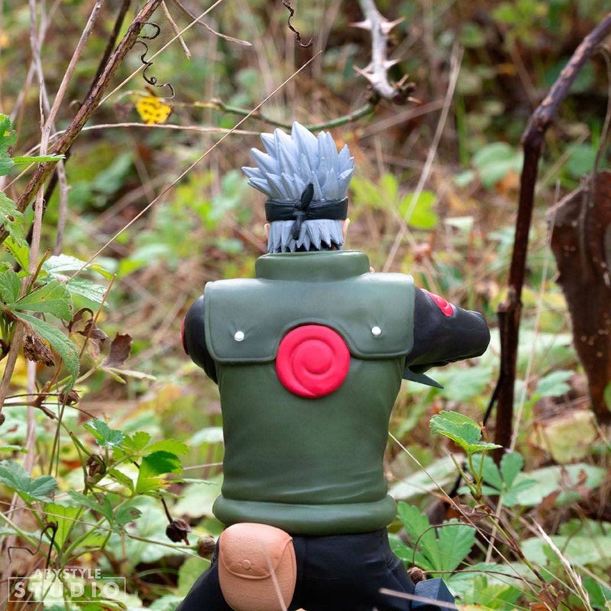 Rear view of ABYstyle Studio Naruto Shippuden Kakashi SFC Figure 16.5cm showing the detailed vest, pouch, and iconic red Uchiha symbol.