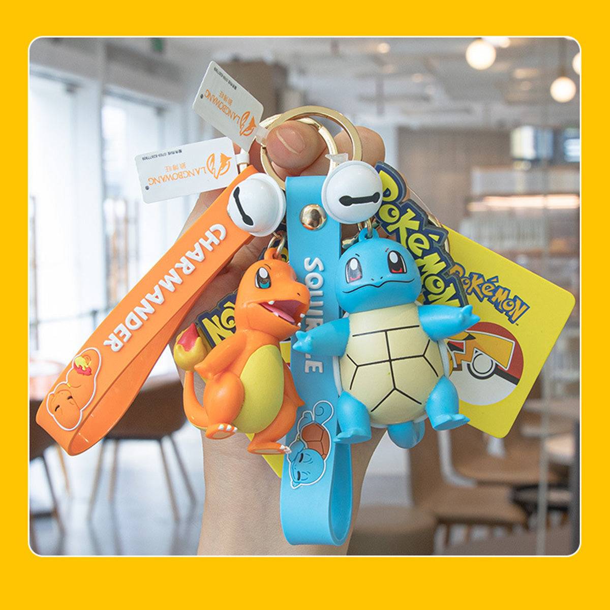 Hand holding Charmander and Squirtle Pokemon figure keychains. A stylish and collectible accessory for Pokemon fans.