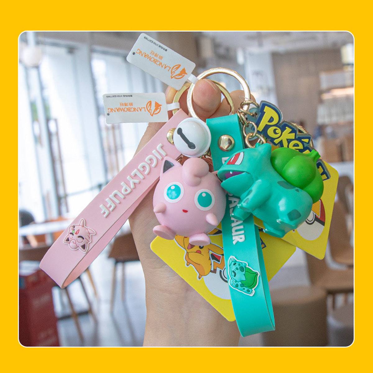 Hand holding Jigglypuff and Bulbasaur Pokemon figure keychains. A fun and stylish anime collectible for fans of all ages.