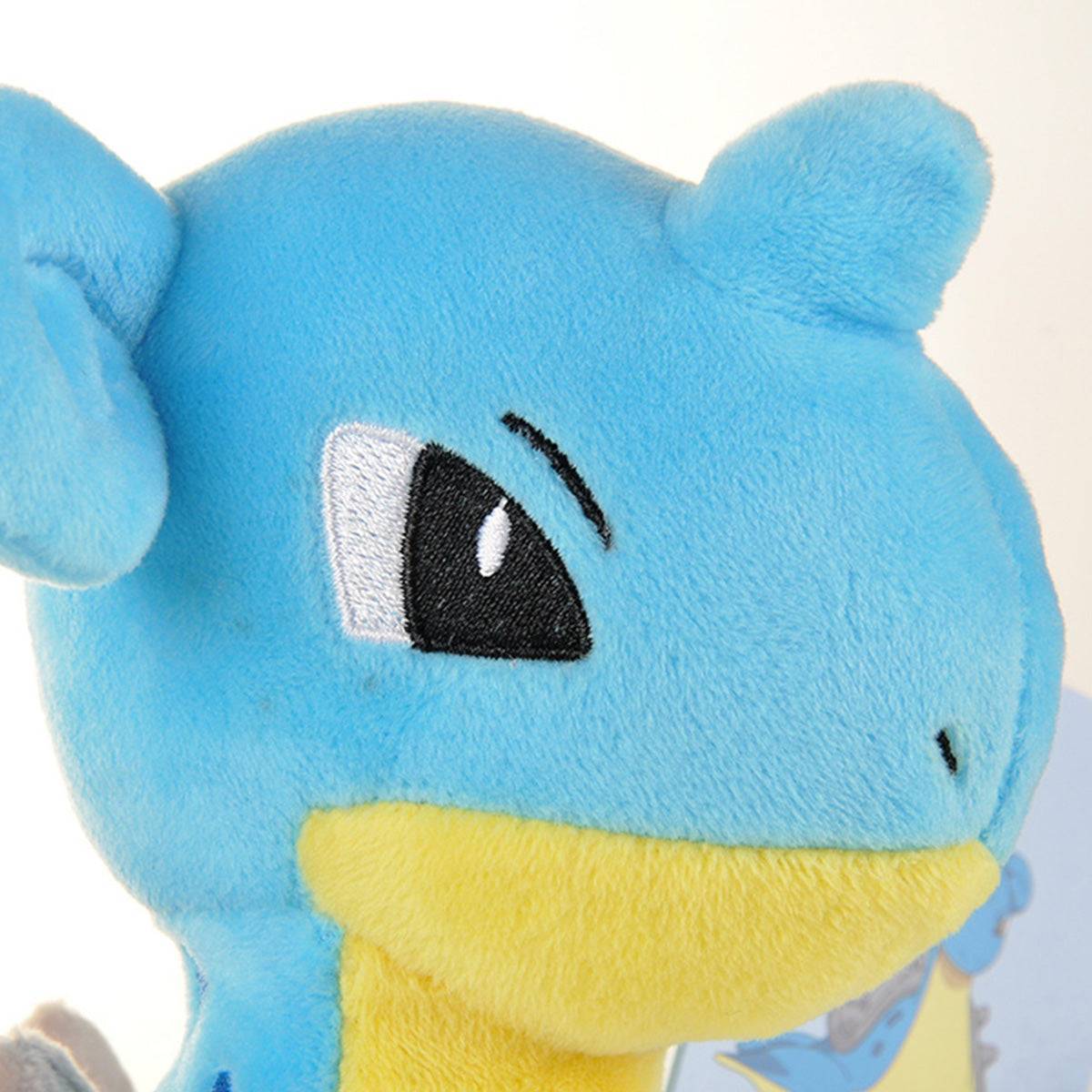 Close-up of the Pokemon Lapras Plush Toy 25cm's embroidered eyes and soft plush fabric. High-quality craftsmanship for collectors and kids.