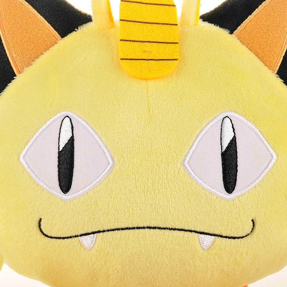 Close-up of Pokemon Meowth Plush Toy 25cm's embroidered face with expressive eyes and signature coin detail. High-quality stitching for durability.