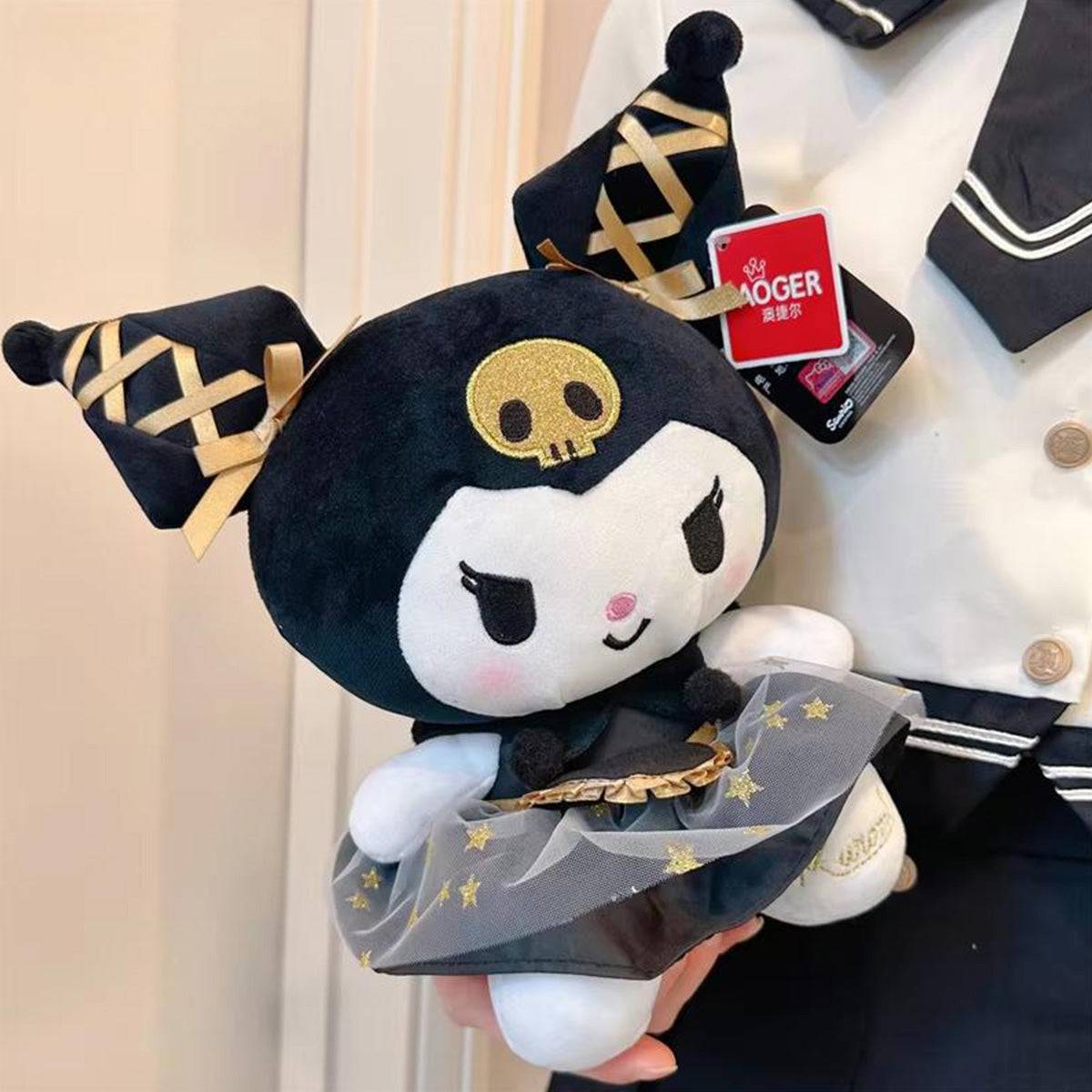 Kuromi plush toy from Sanrio’s Black Gold Series being held, emphasizing its luxurious black and gold theme with a stylish skirt and accessories.
