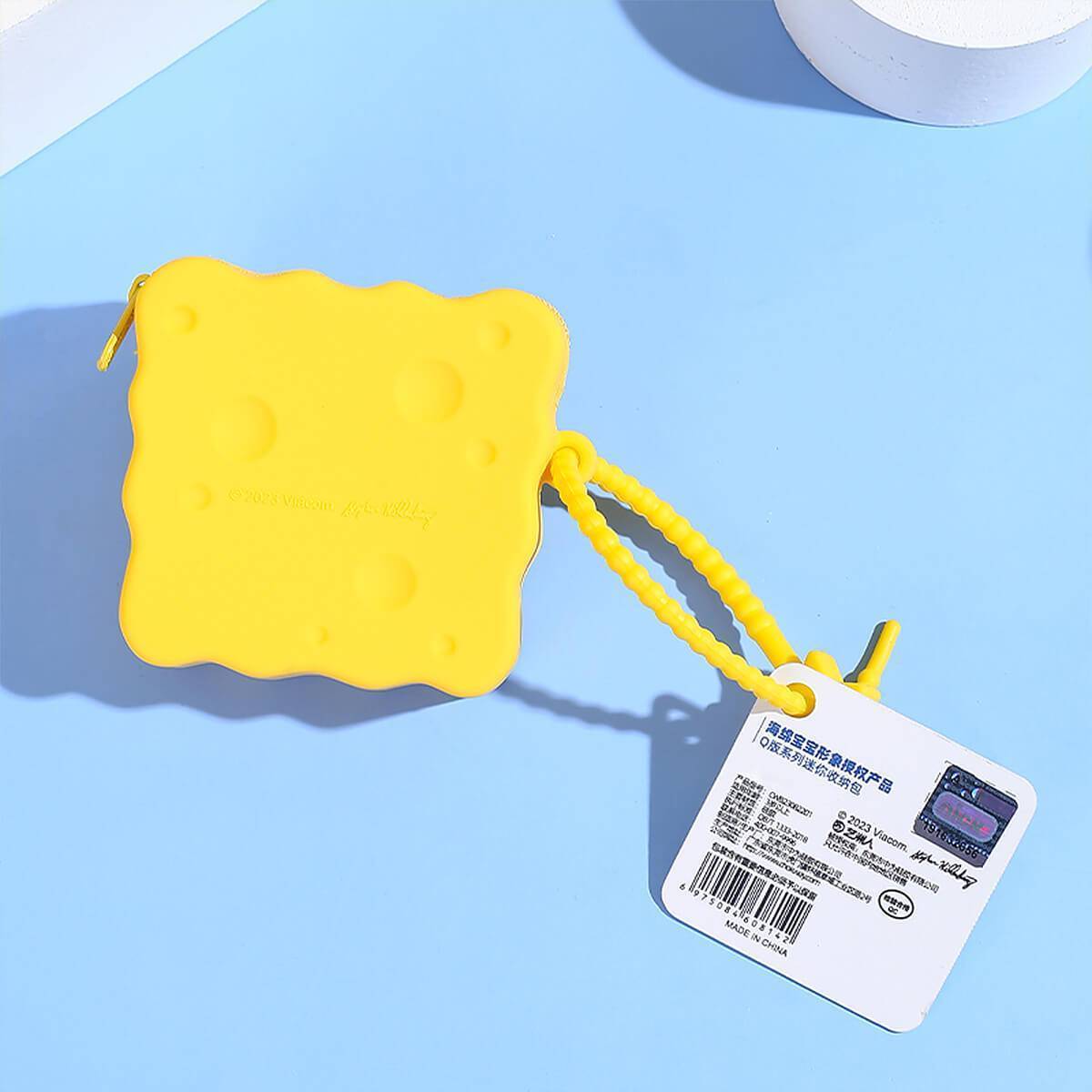 Back view of the SpongeBob SquarePants silicone coin purse with a tag. A waterproof and durable storage option for small essentials.