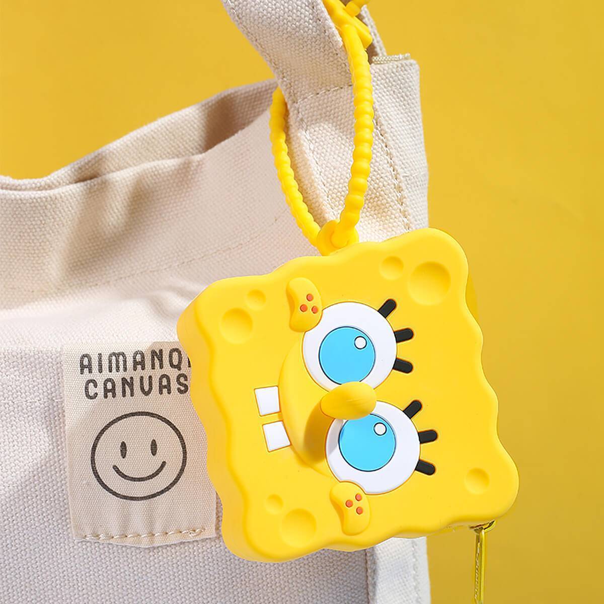 SpongeBob SquarePants silicone coin purse attached to a canvas bag. A cute and portable accessory for kids and cartoon lovers.