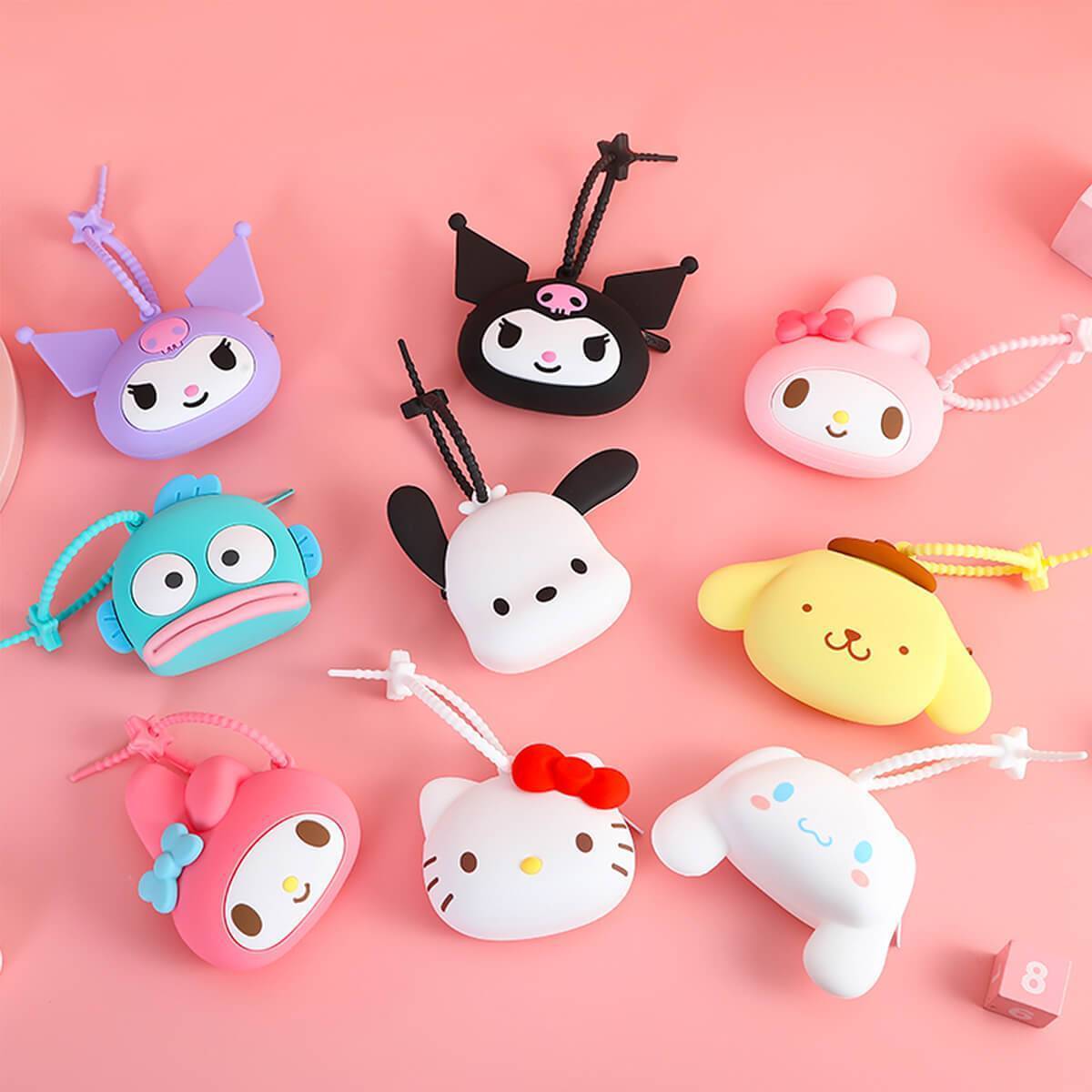 Flat lay of multiple Sanrio character silicone coin purses in various colors. A fun and practical accessory collection for anime lovers.