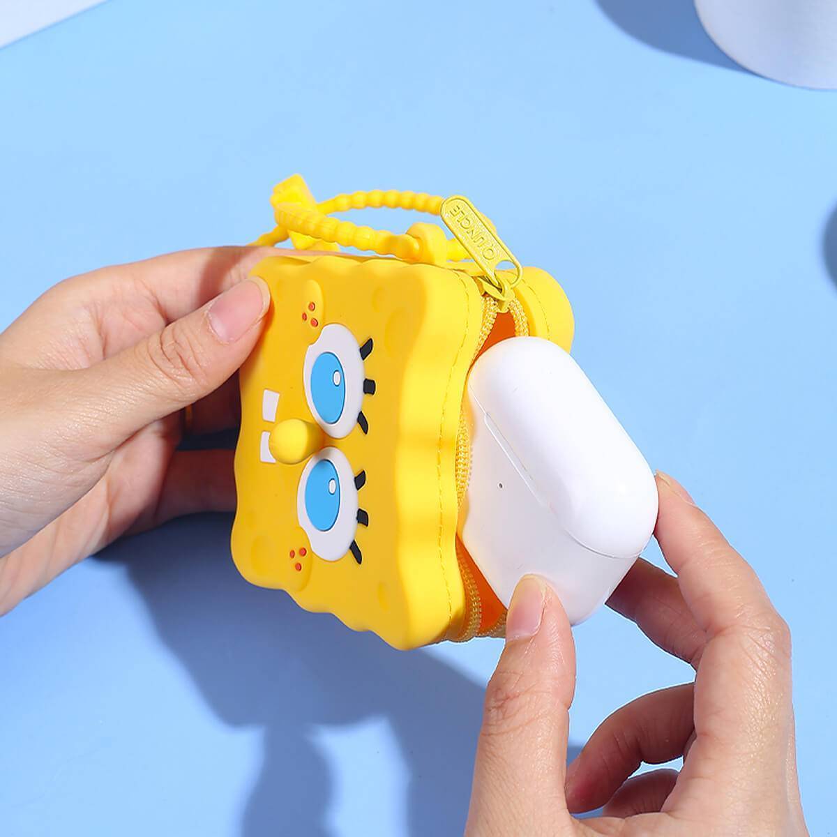 SpongeBob SquarePants silicone coin purse being used to store wireless earbuds. A fun and practical storage solution for small essentials.