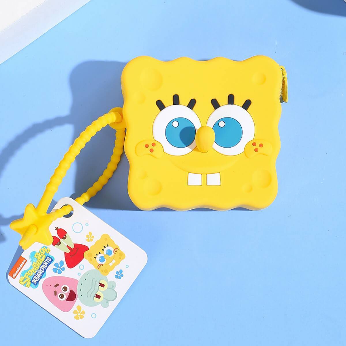 SpongeBob SquarePants silicone coin purse with a tag featuring other cartoon characters. A collectible and practical accessory for kids.