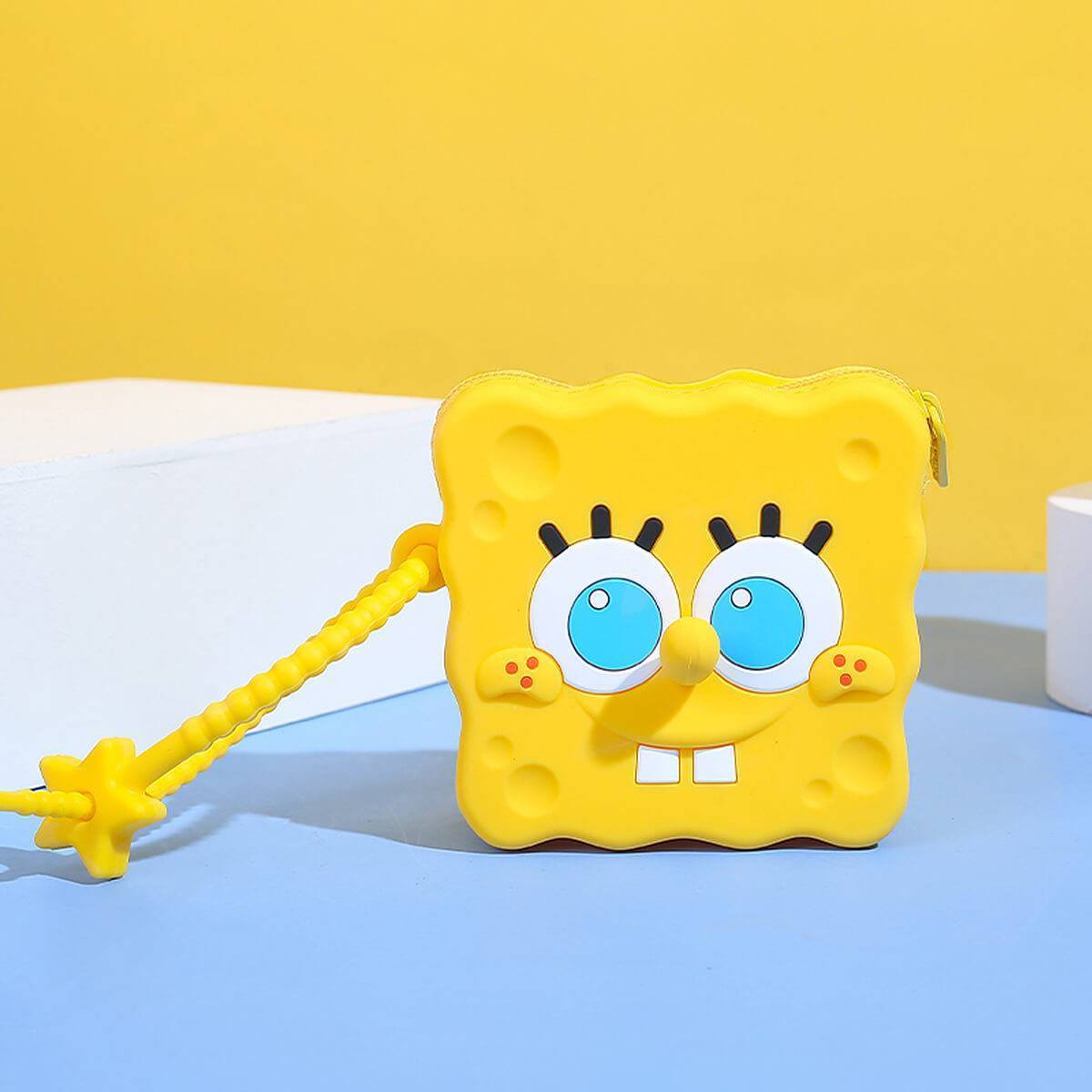 SpongeBob SquarePants silicone coin purse displayed on a blue and yellow background. A fun and durable storage option for small items.