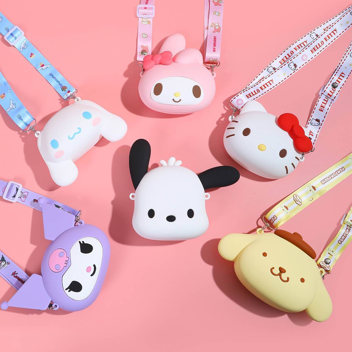 Flat lay of multiple Sanrio Cartoon Silicone Mini Crossbody Bags in different character designs with colorful straps.