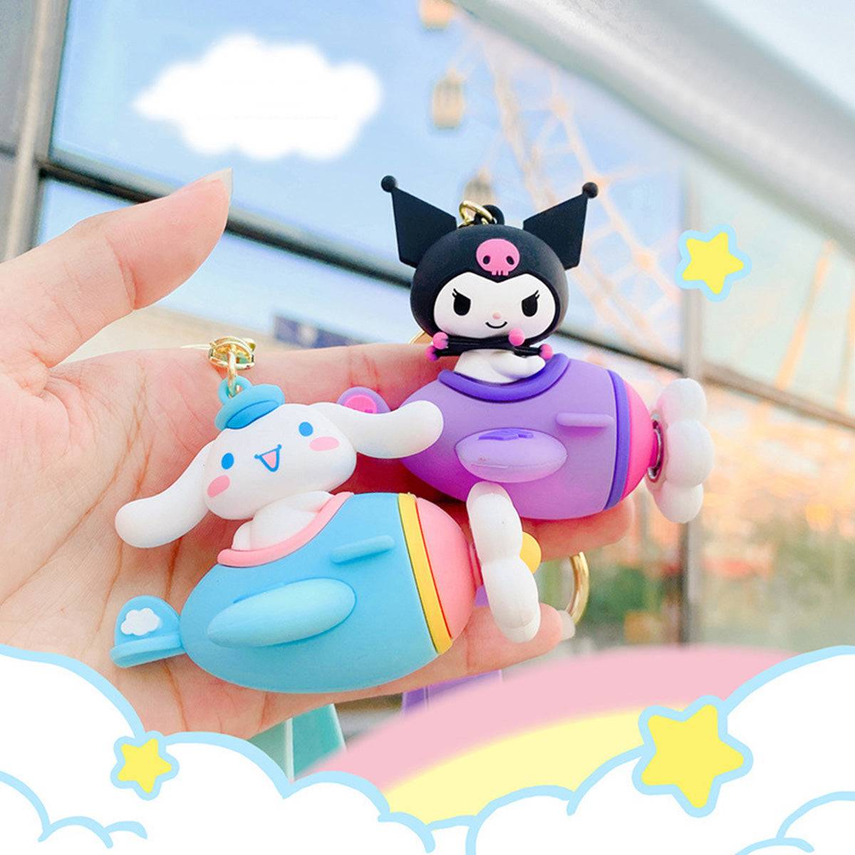 Kuromi and Cinnamoroll Airplane Keychains held outdoors with a dreamy sky background. A stylish and playful Sanrio collectible.