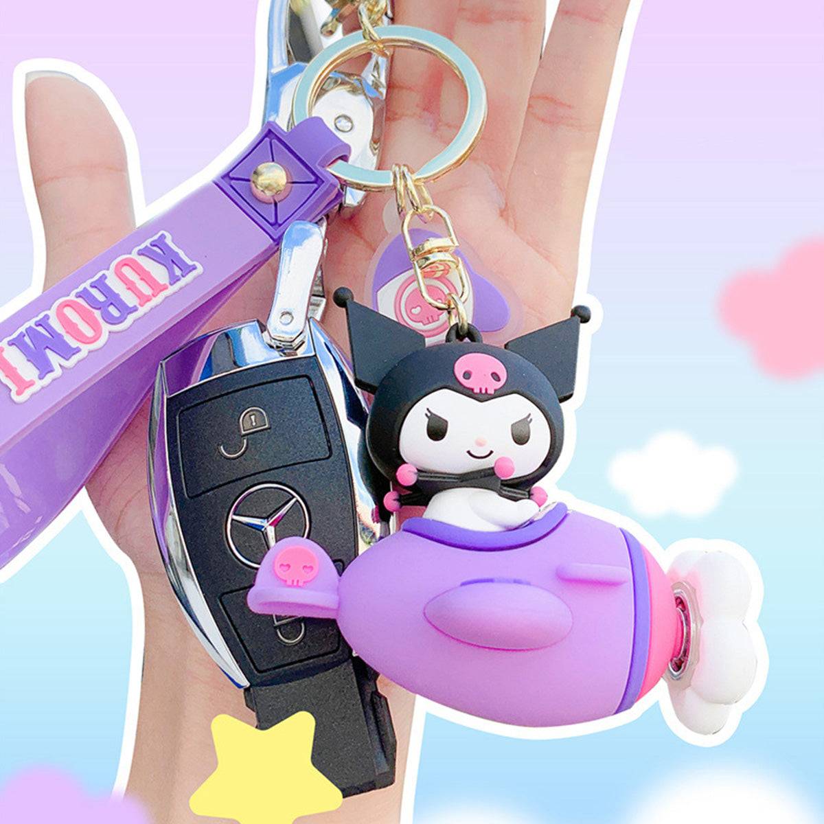 Kuromi Airplane Keychain attached to a car key, featuring a purple design with a matching wrist strap. A trendy and fun Sanrio accessory.