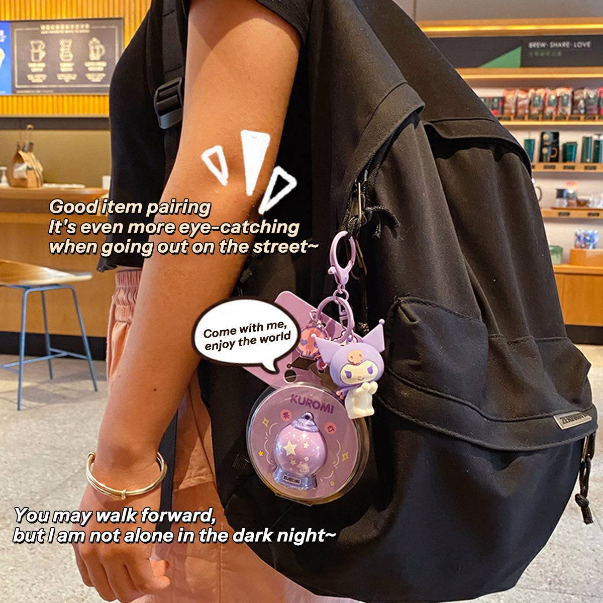 Kuromi Sanrio Characters Keychain with Night Light attached to a black backpack. A stylish and functional accessory for fans on the go.