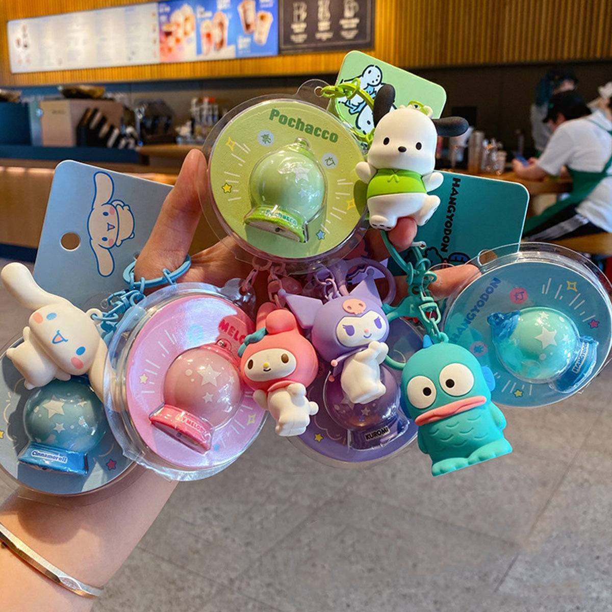 Hand holding multiple Sanrio Characters Keychains with Night Lights. A fun and colorful collection for fans of Sanrio mascots.