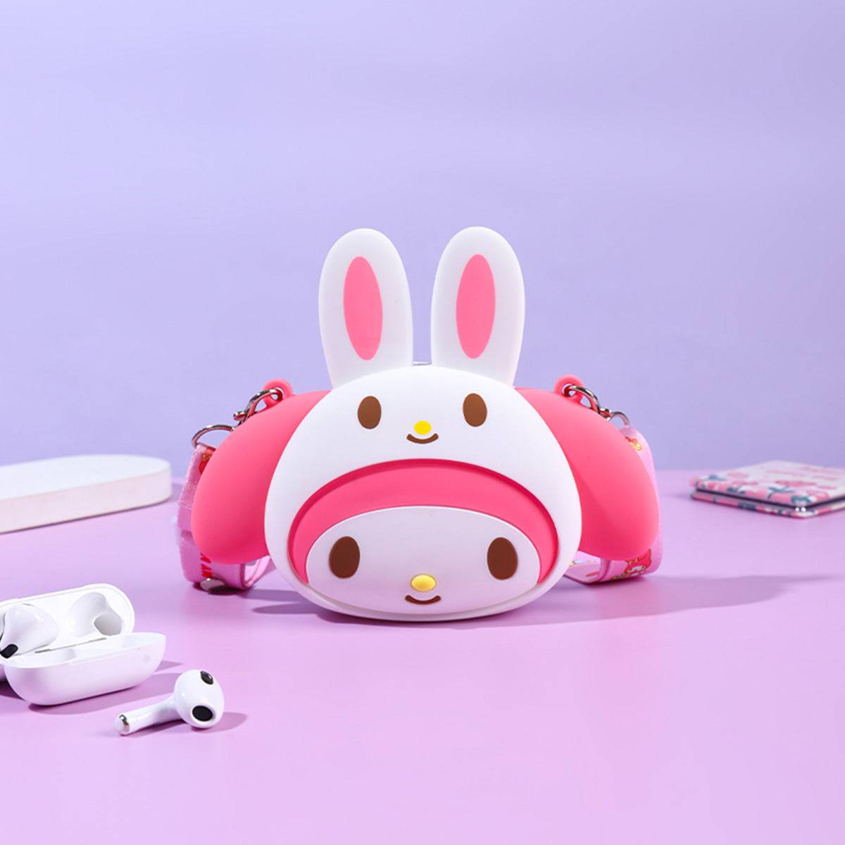 Sanrio Characters Mini Silicone Crossbody Bag featuring a pink My Melody design with bunny ears. A cute and durable accessory for Sanrio fans.