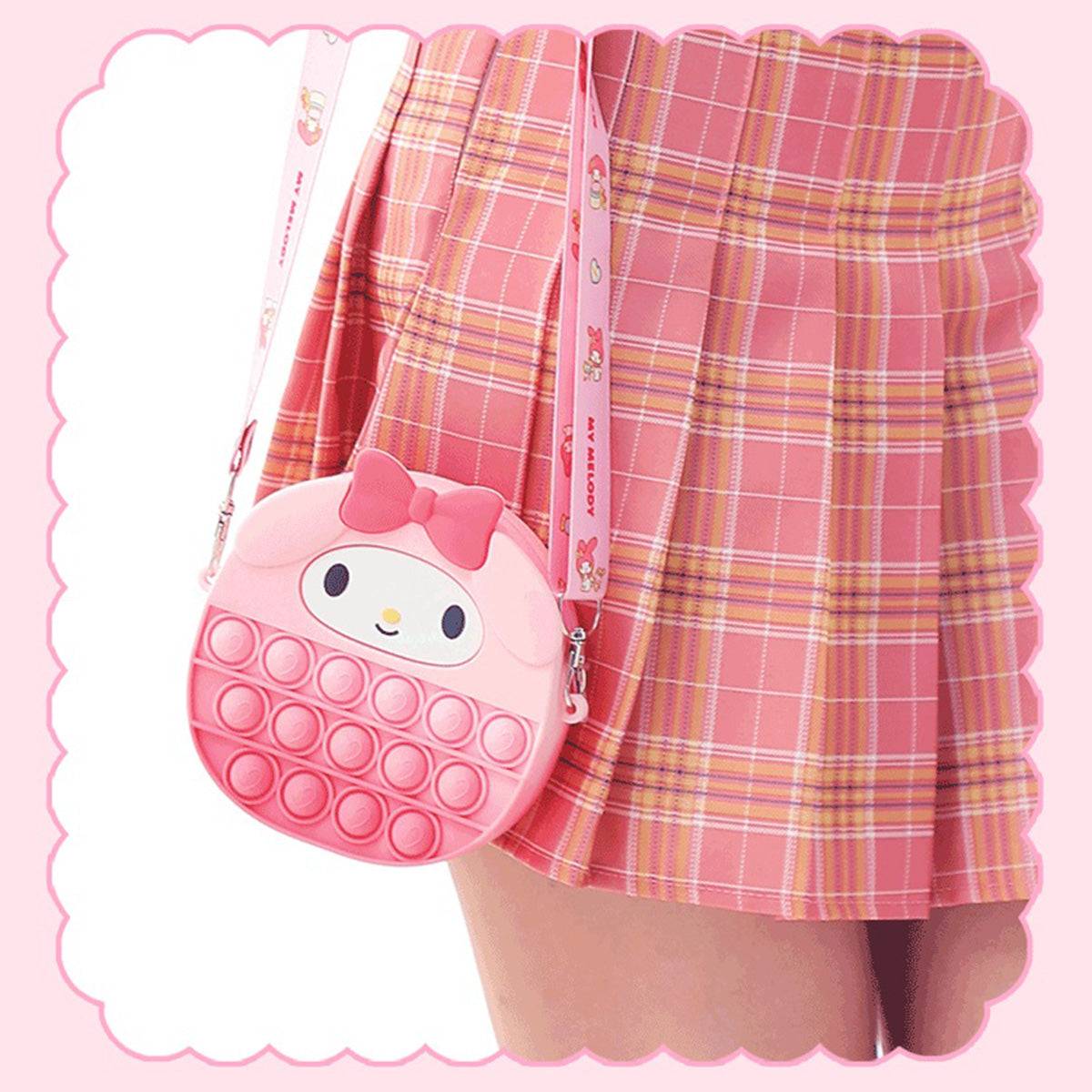 My Melody Pop It Bag displayed on a model, showing its compact size and adorable design. A perfect accessory for Sanrio fans and fidget toy lovers.