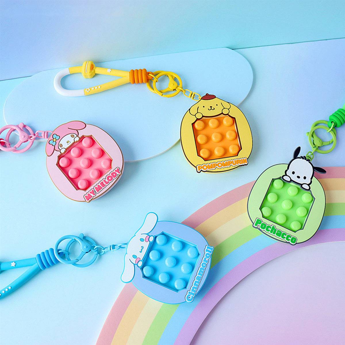 Sanrio Pop It Fidget Keychains featuring My Melody, Pompompurin, Pochacco, and Cinnamoroll. A colorful and fun collection for stress relief.