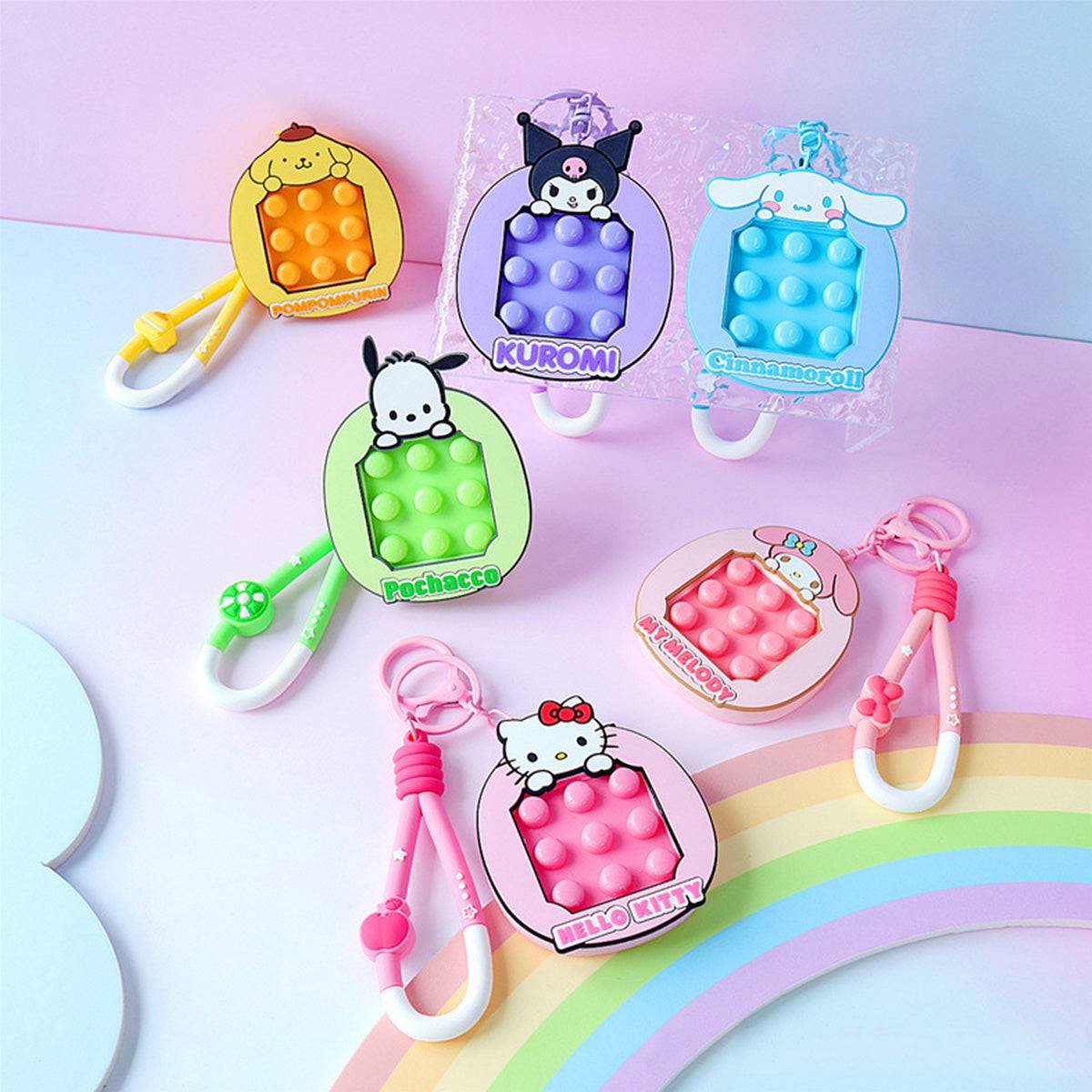 Sanrio Pop It Fidget Keychains in various designs, including Kuromi, Cinnamoroll, and Pochacco. A fun and portable stress-relief accessory.