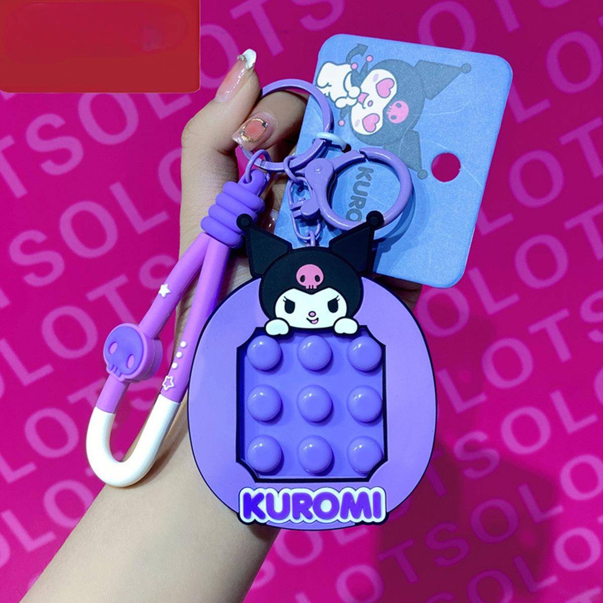 Kuromi Pop It Fidget Keychain from Sanrio in purple with a matching carabiner clip. A fun and portable stress-relief toy for fidgeting on the go.