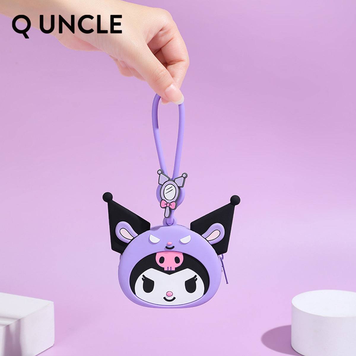 Kuromi silicone coin purse being held by its wrist strap, emphasizing its lightweight and portable design. Ideal for kids and collectors.