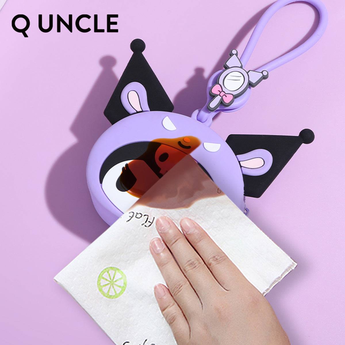 Waterproof Kuromi silicone coin purse being wiped clean, demonstrating its easy-to-maintain material. A durable and stylish accessory.