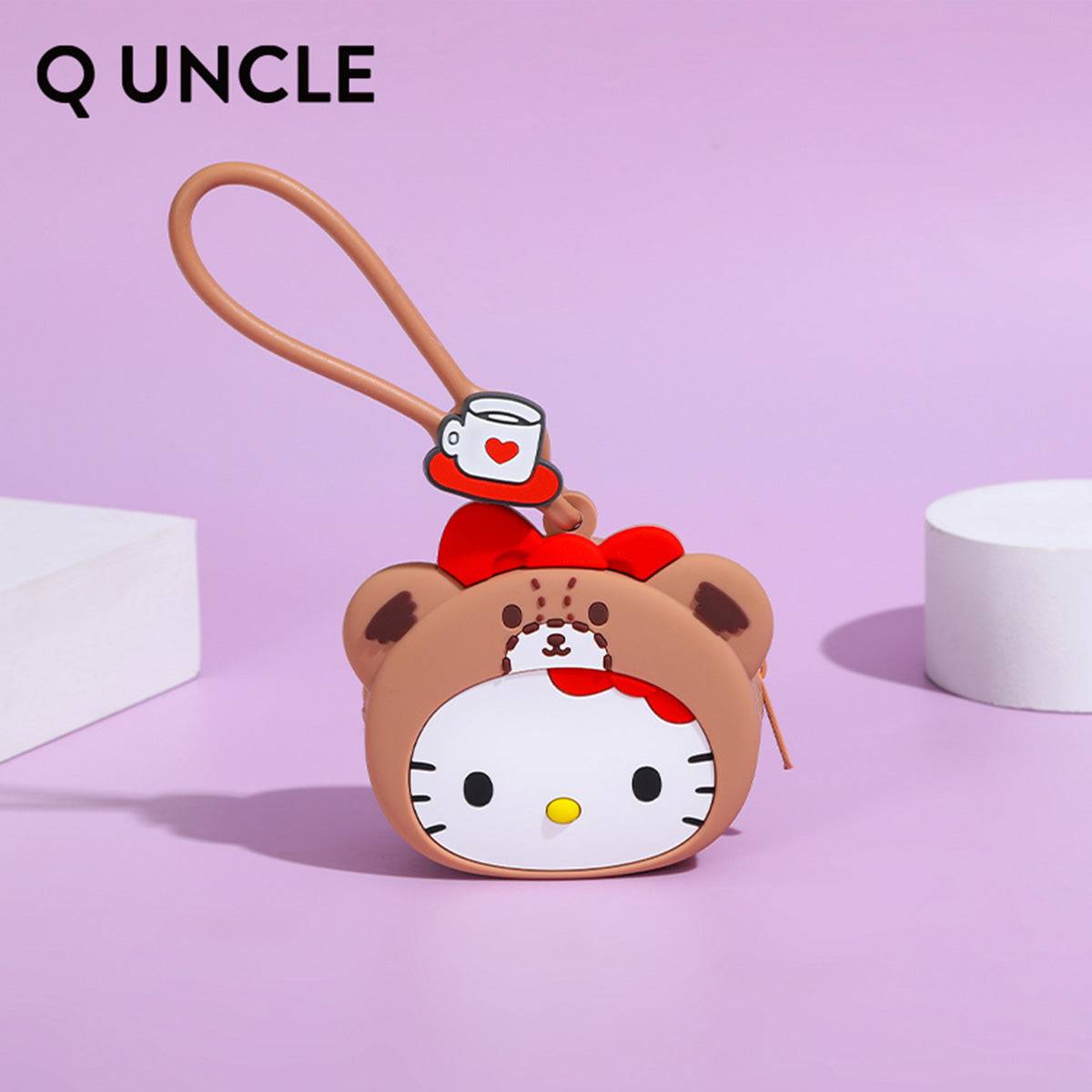 Hello Kitty bear-themed silicone coin purse in brown with a red bow and coffee cup charm. A charming gift for Sanrio lovers.