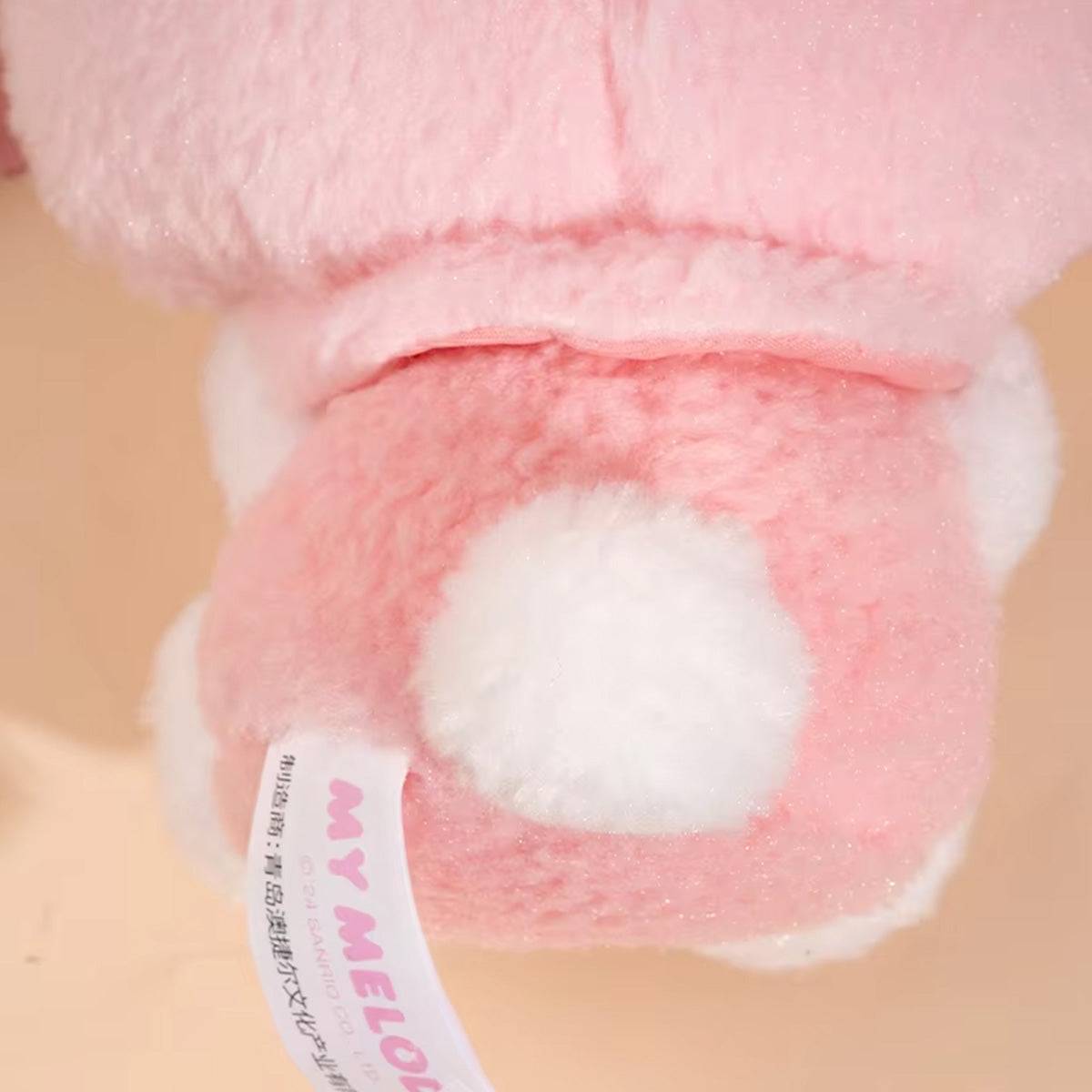 Back view of My Melody plush keychain from Sanrio Cute Justice Series, showing fluffy tail and soft pink fur with a branded tag.