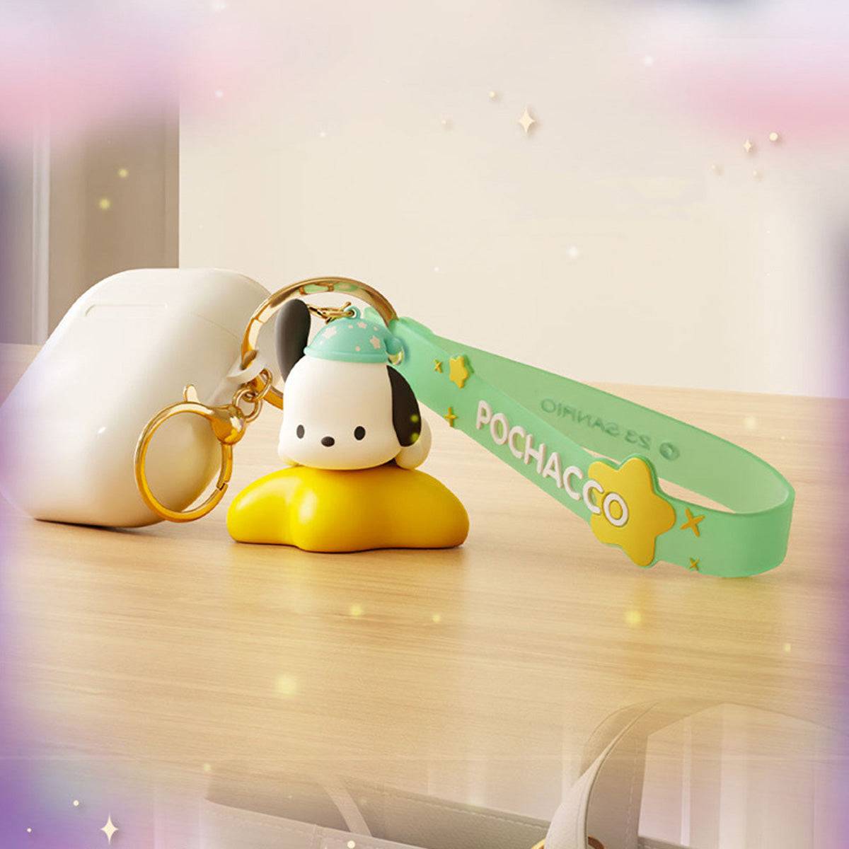 Pochacco Sanrio Family Star Night Light Series Pendant Keychain attached to an AirPods case, featuring a glowing yellow base and green strap.