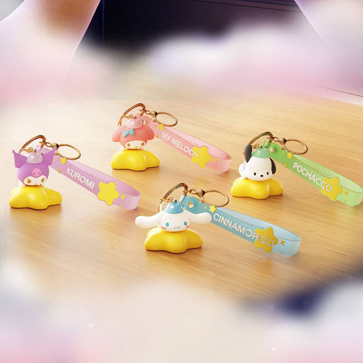 Sanrio Family Star Night Light Series Pendant Keychains arranged on a wooden surface, showcasing their adorable glowing designs and vibrant straps.