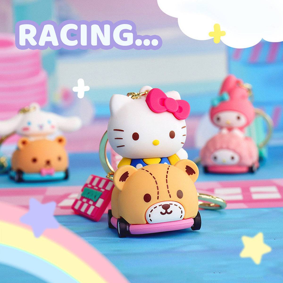 Sanrio racing keychains featuring Hello Kitty, My Melody, Kuromi, and Cinnamoroll in rolling wheel cars on a colorful track.