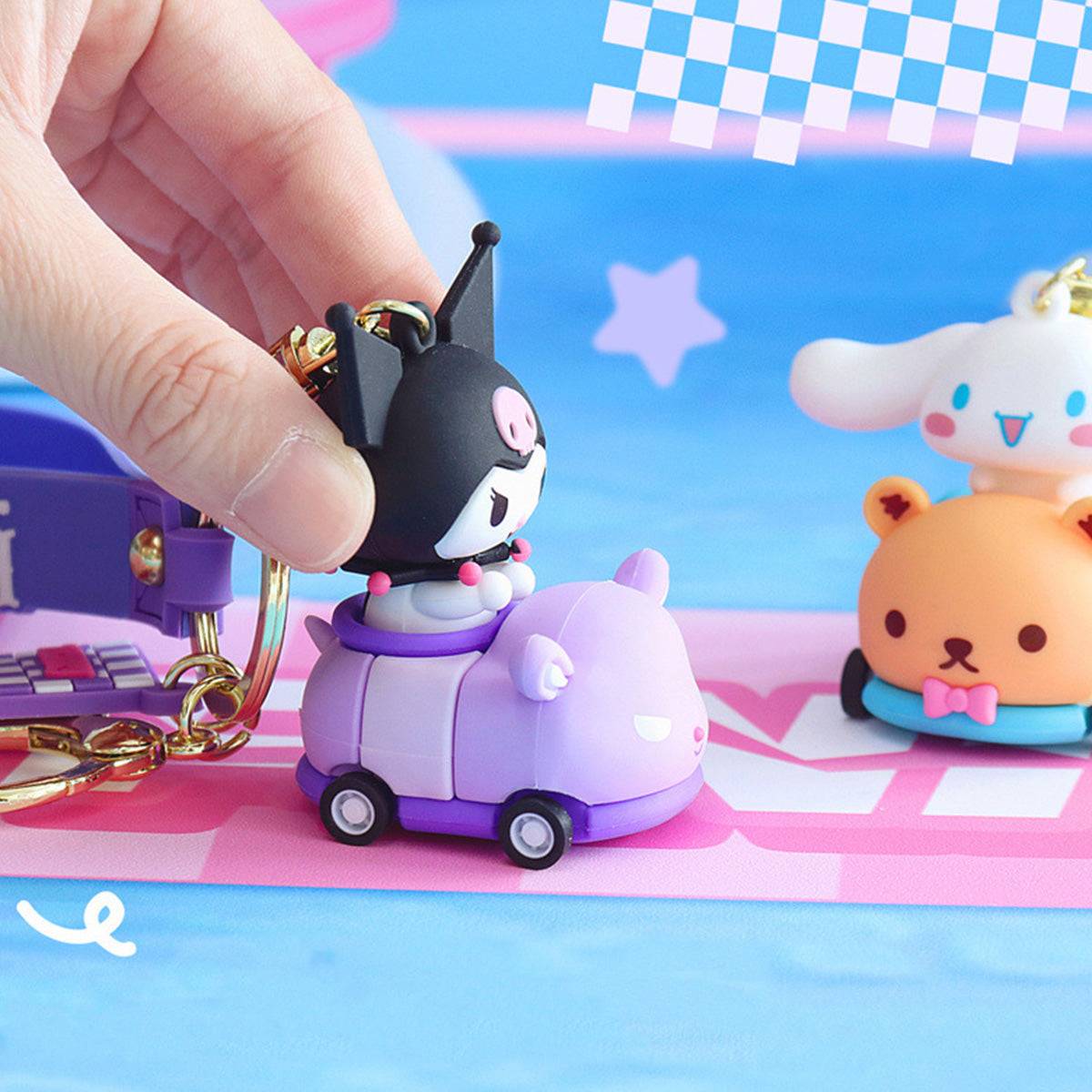 Kuromi Sanrio keychain in a purple race car with rolling wheels, being pushed on a colorful racing track.