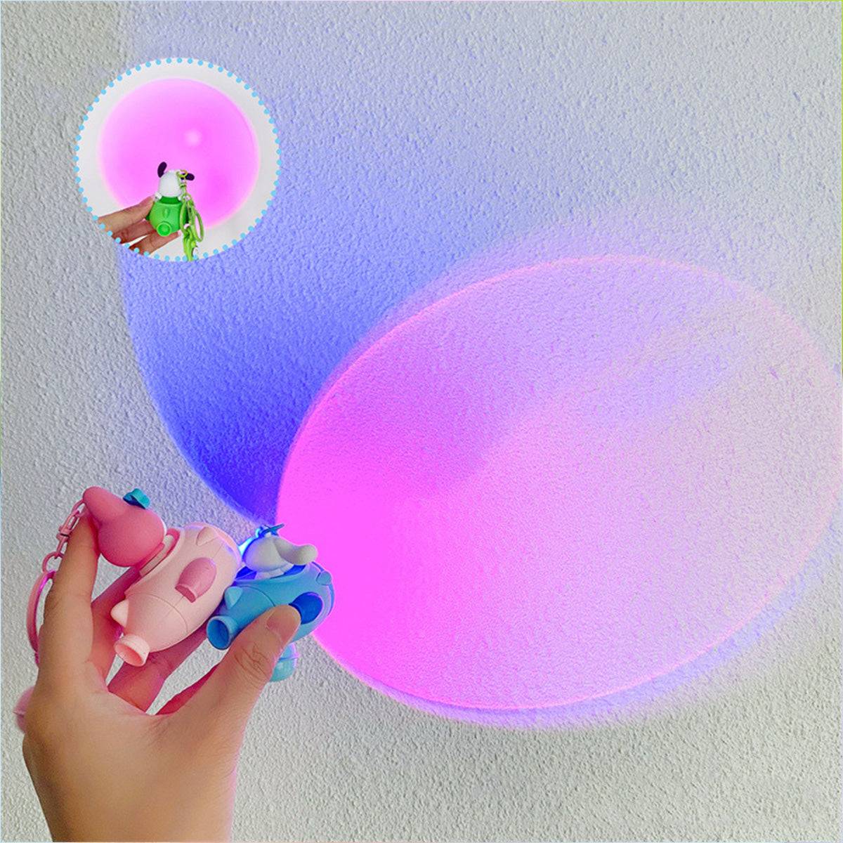Sanrio Sunset Light Spaceship Keychains projecting a vibrant pink and purple glow on a wall. A fun and decorative accessory for fans.