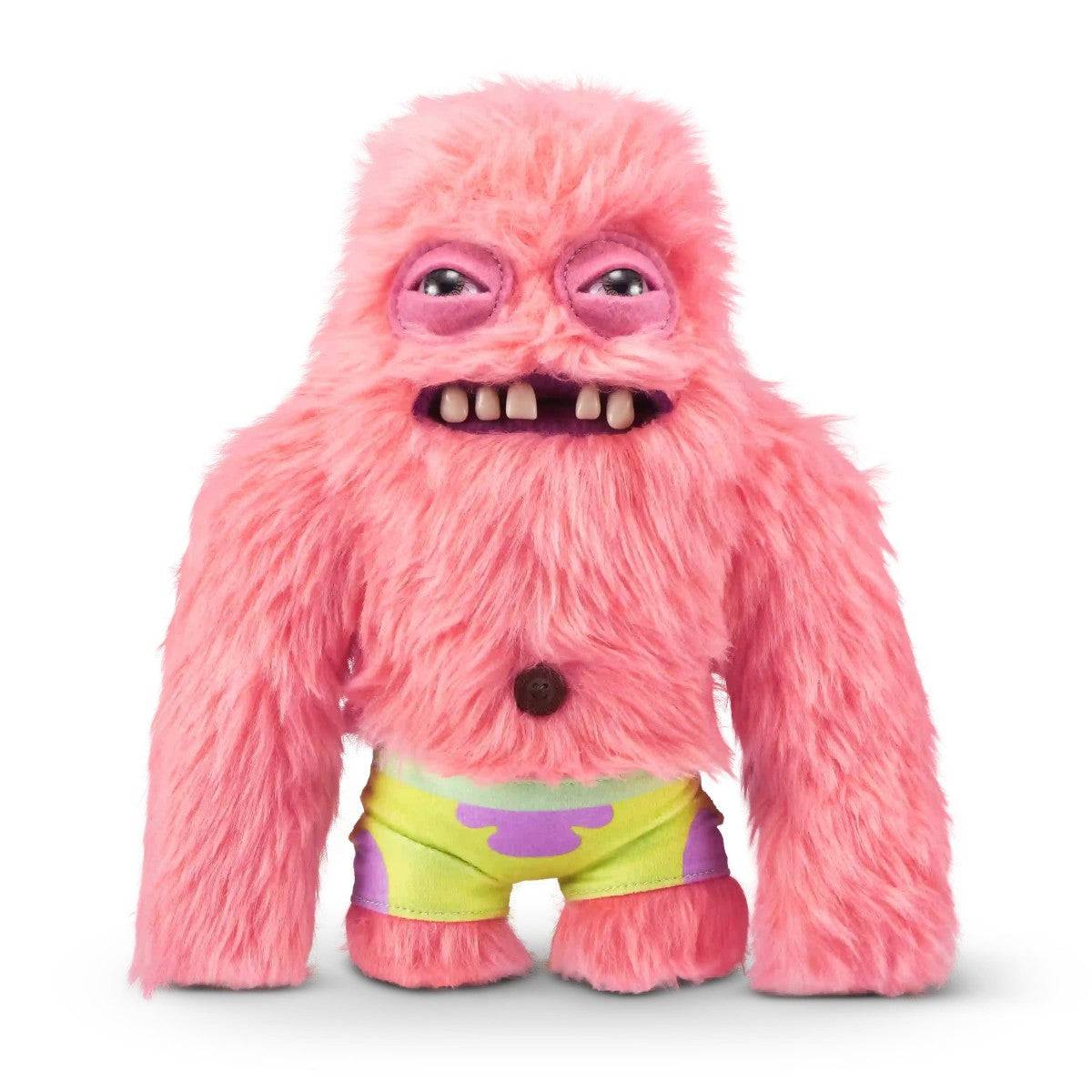 FUGGLER Soft Plush Toy in pink fur with exaggerated teeth and colorful shorts. A humorous stuffed animal for playful toy collections.