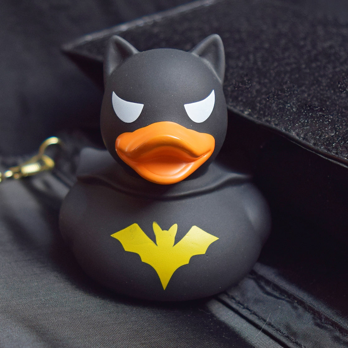 Lilalu Rubber Duck in a superhero costume with a black cape and bat symbol. A heroic bath toy from the Lilalu Rubber Ducks Baby Bath Toys Blind Box.