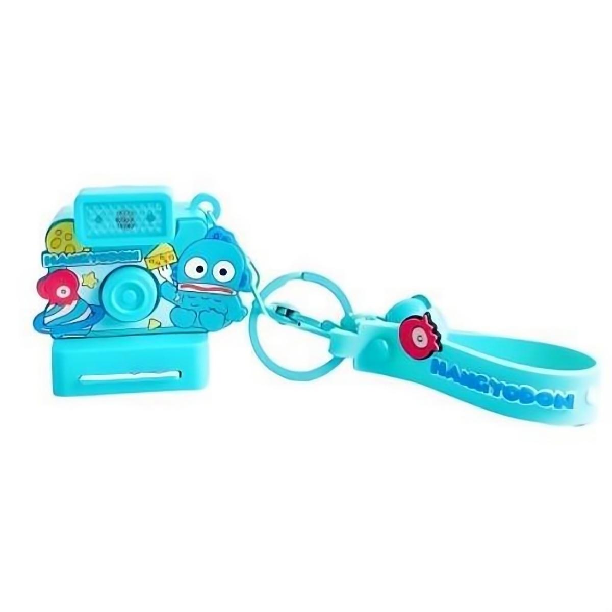 Hangyodon-themed Sanrio Characters Polaroid Camera Keychain in blue with a fun design, bell charm, and wrist strap. A unique collectible for fans.