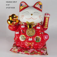 Red 14-inch Lucky Cat Figurine with gold ingots and floral ears, seated on red cushion. Decorative action figure for prosperity and charm.