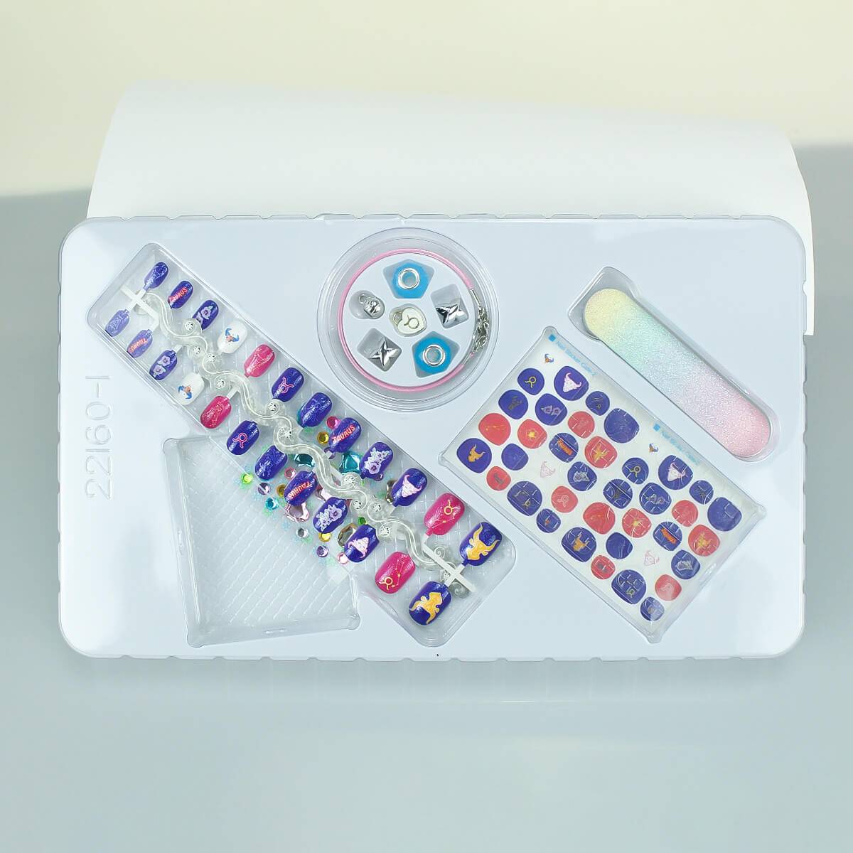 Inside view of the 12 Zodiac Signs Kids Nail Art Set HW23158395, showcasing Taurus-themed nail stickers, charms, and accessories.